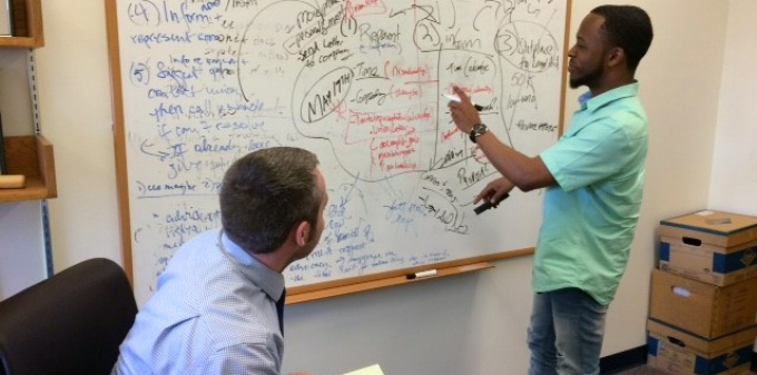 Health Justice Clinic student attorneys Donell Gibson '18 and Eric Weyand '18 strategize about a client representation. 