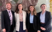 people standing in front of an abstract mural.