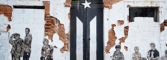 black and white Puerto Rican flag painted on brick. 