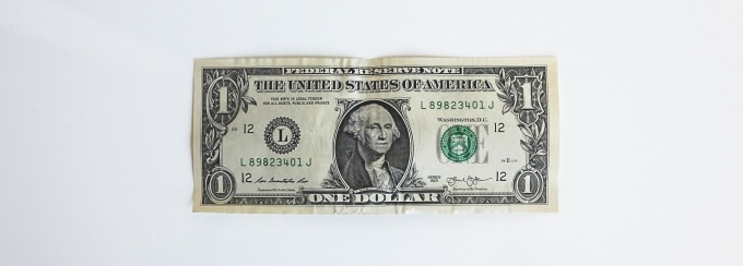 photo of a dollar bill on a white background. 