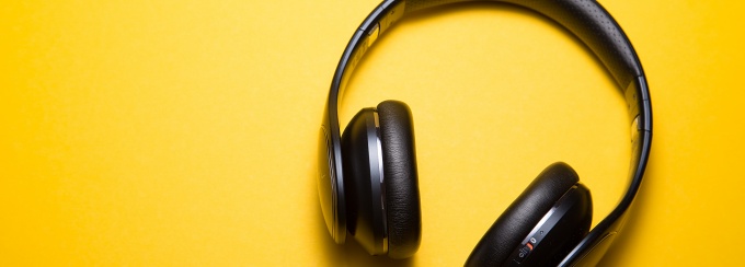 photo of headphones on a yellow background. 