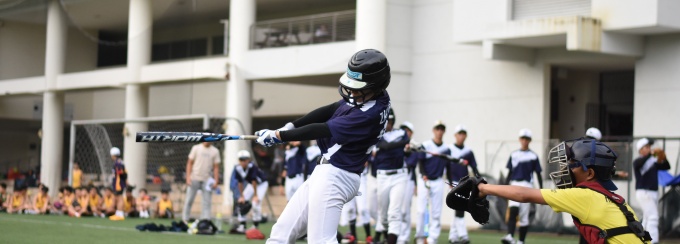 photo of a baseball game with the hitter swinging the bat.