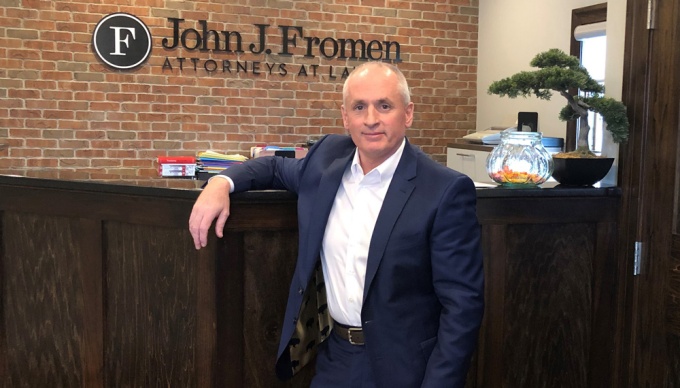 John J. Fromen Jr. ’87 in front of the reception desk at his practice. 