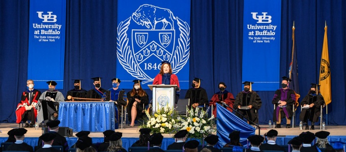 photo of Aviva speaking at a podium at the commencment ceremony. 