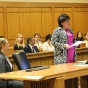 attorney in a courtroom with students observing in the audience. 