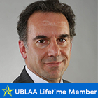 man, smiling with text under photo that says UBLAA Lifetime Member. 