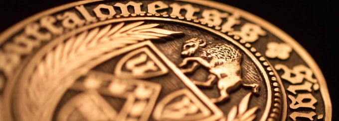 closeup image of gold medallion. 