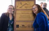 Photo of Bridget Steele and Kim Connolly posing with designation plaque. 