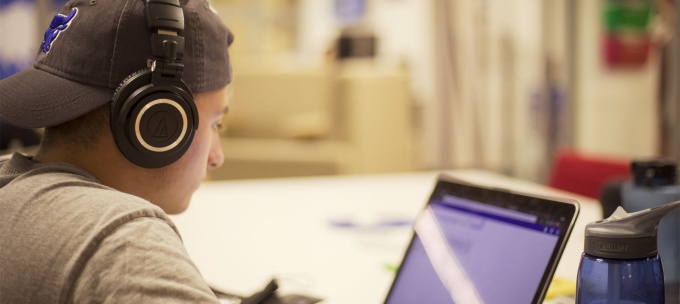 student reading a computer screen. 