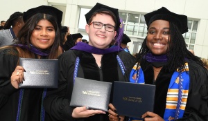 recent graduates wearing cap and gown. 