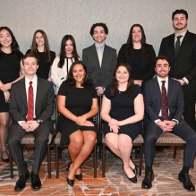 Formal group portrait of Buffalo Law Journal members dressed in business attire, arranged in two seated and standing rows against a neutral indoor background.