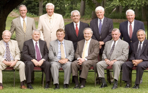 photo of alumni looking at an old student directory. 