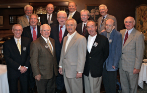 photo of alumni looking at an old student directory. 