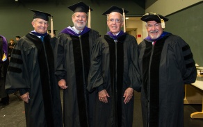 photo of alumni looking at an old student directory. 