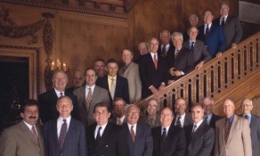 photo of alumni looking at an old student directory. 