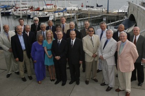 group of alumni standing together, posing for their group photo. 