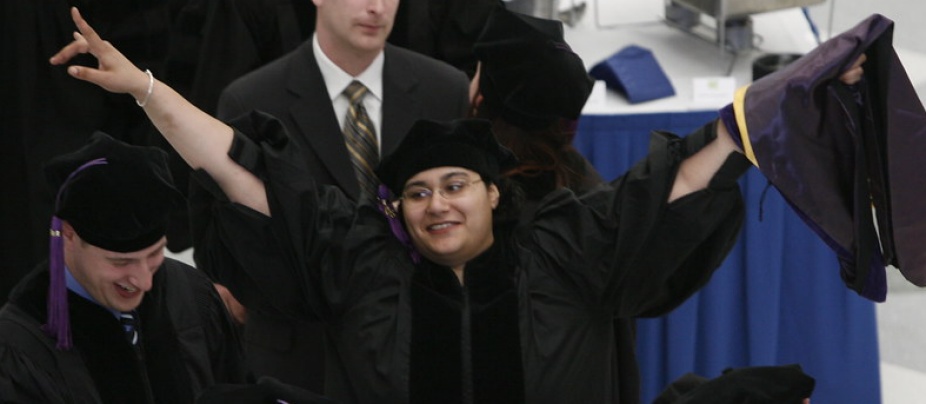 students standing with graduate. 