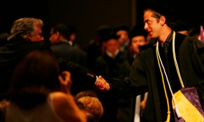 photo of law graduates cheering. 