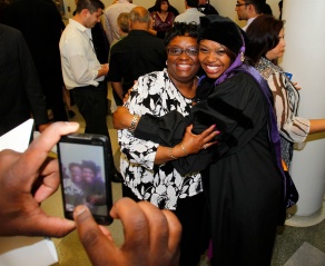 photo of law graduate getting their photo taken with a family member. 
