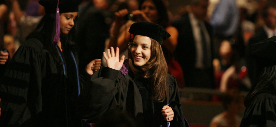 photo of graduate getting hooded during their commencement ceremony. 