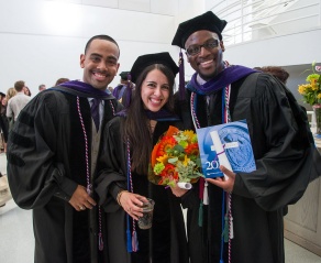 a recent law school graduate posing with her family following commencement. 