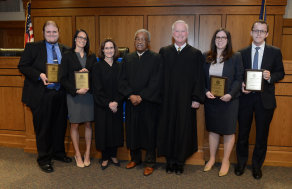 Desmond winners and judges posing with their awards. 