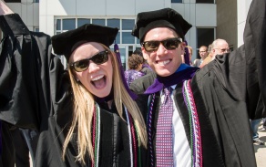 photo of 2 law graduates cheering. 