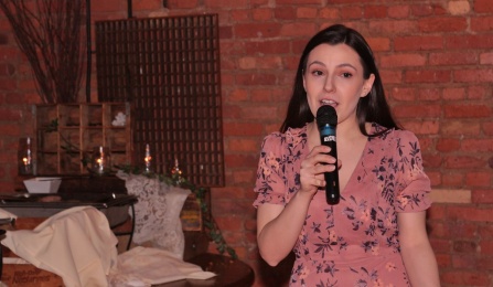 woman speaking into a microphone. 