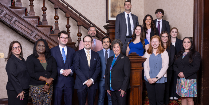 a large group of people standing a set of stairs. 