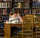 photo of student working in the library. 