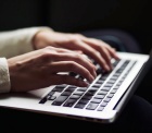 photo of person typing on a computer keyboard. 