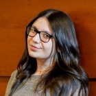 Elnara Karadzhayeva standing against a wall. 