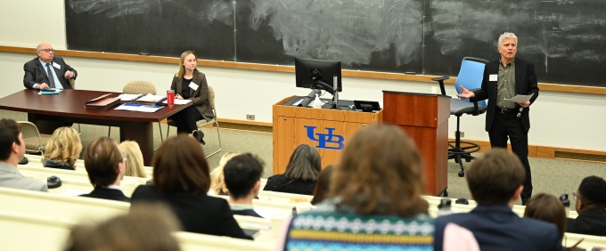 Speaker addresses an audience in a University at Buffalo School of Law lecture hall during an academic event.