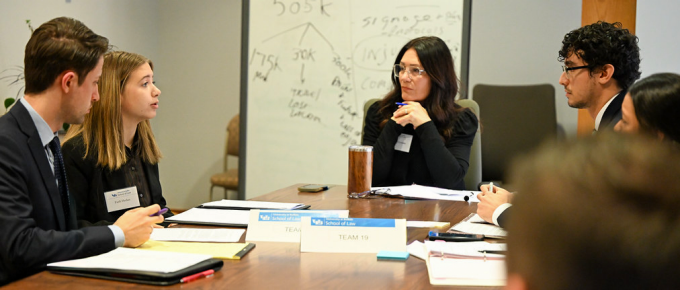 Law students participate in a mediation exercise with a facilitator during a dispute resolution program. 