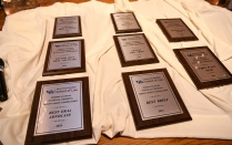 awards lined up on a table top. 