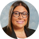 young woman wearing glasses, smiling. 