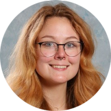 young woman wearing glasses, smiling.