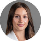 young man wearing a suit and tie, smiling. 