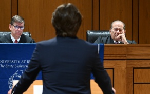 Participant presents an argument before a panel of judges during a moot court competition at the University at Buffalo School of Law.