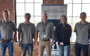 The Veterans Law Practicum students and the Director at the table at a University at Buffalo Clinical Legal Education event, with informational forms for veterans. 