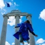 photo of UB undergrad jumping in the air at graduation. 