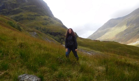 Zoom image: UB Law student standing in the middle of mountains in Glasgow, Scotland