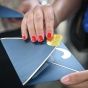 Blue envelope with a gold seal being opened. 