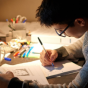 A student studying at a desk. 