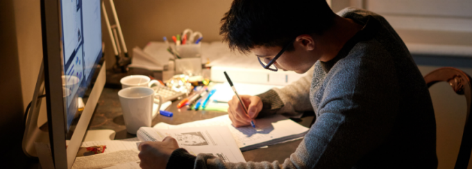 A student studying at a desk. 