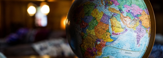 A colorful globe set on a tabletop. 