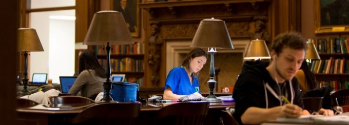 UB students studying in a library. 