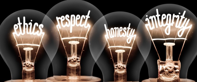 Four light bulbs light up the following words: ethics, respect, honesty, integrity. 