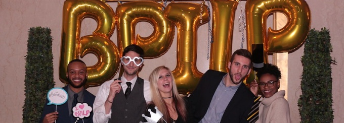 Picture of law students posing in front of large gold balloons that spell out BPILP. 