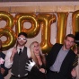 Picture of law students posing in front of large gold balloons that spell out BPILP. 